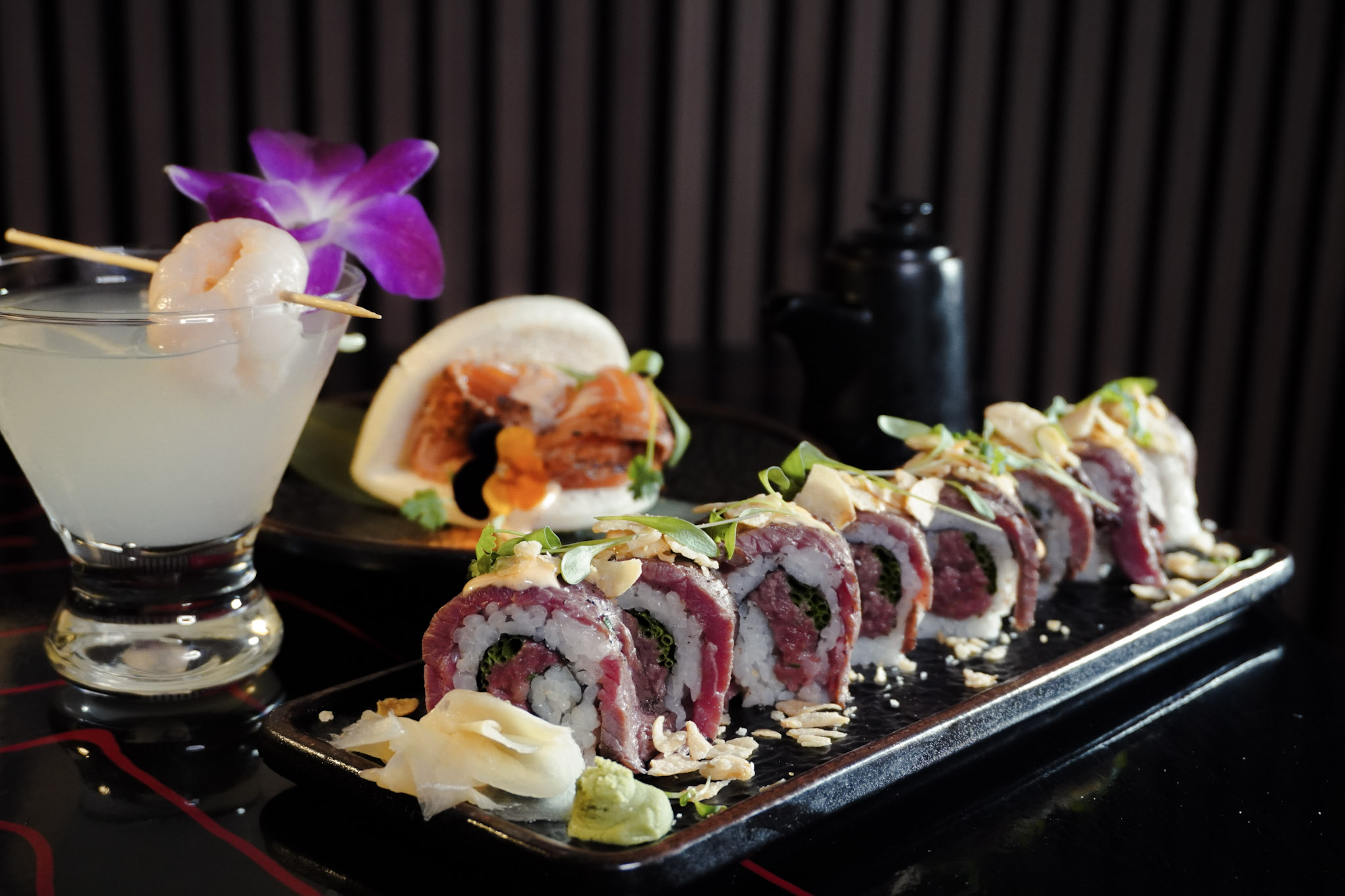 Beef sushi roll with cocktails and bao.