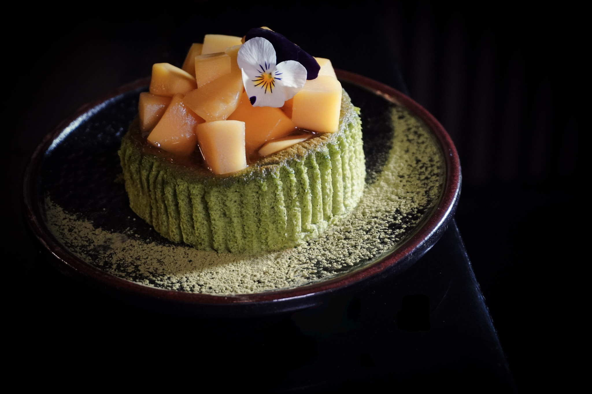 Matcha dessert with mango and pansy.